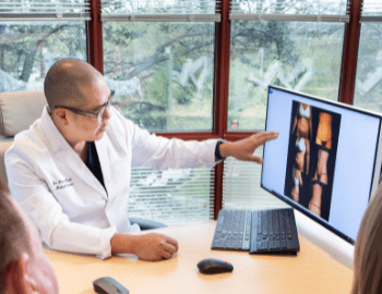 Dr. Kwak Pointing at Screen